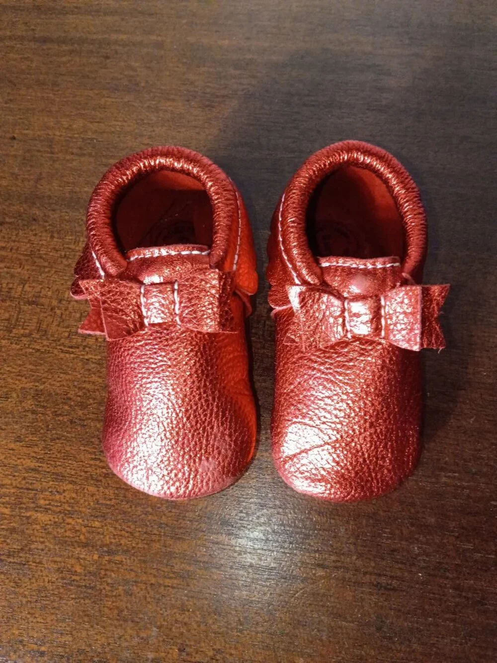 Freshly picked ruby red baby mocassins with bow and ruffles size 5